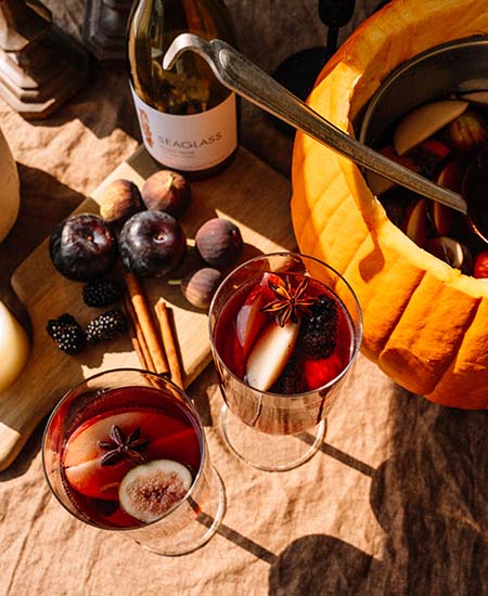 A bottle of SEAGLASS Pinot Noir in front of a pumpkin bowl