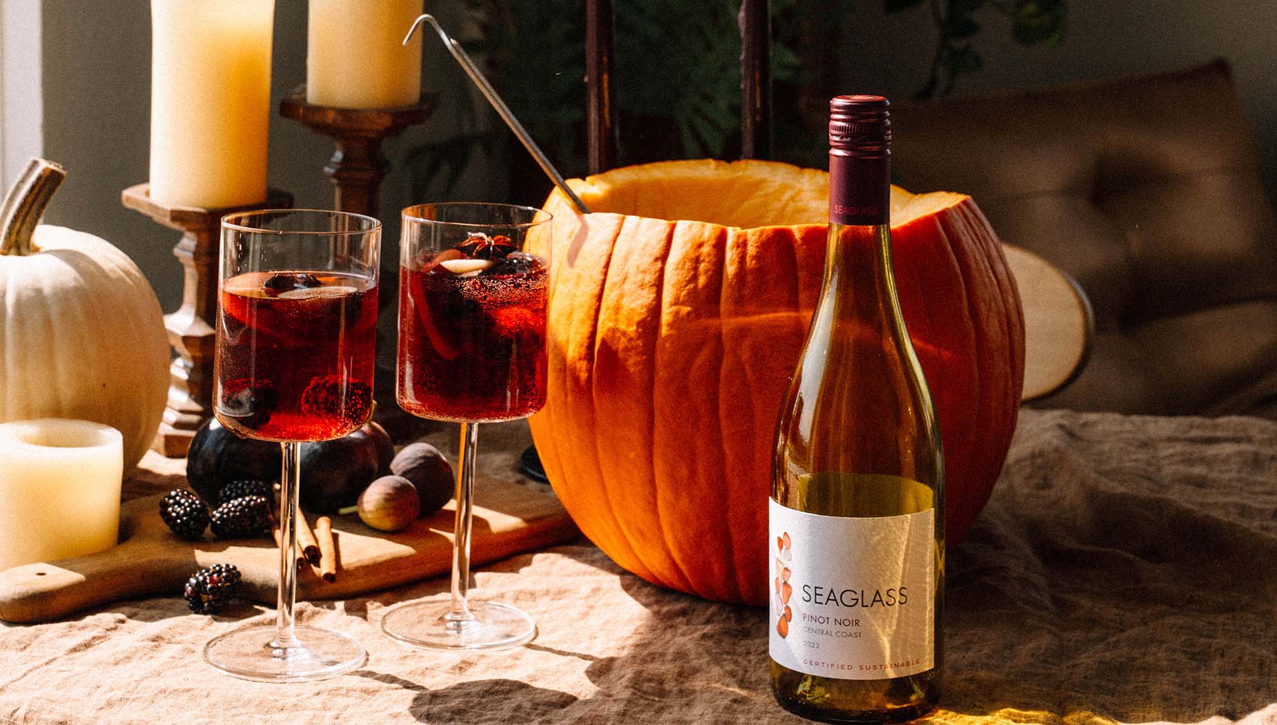 A bottle of SEAGLASS Pinot Noir in front of a pumpkin bowl